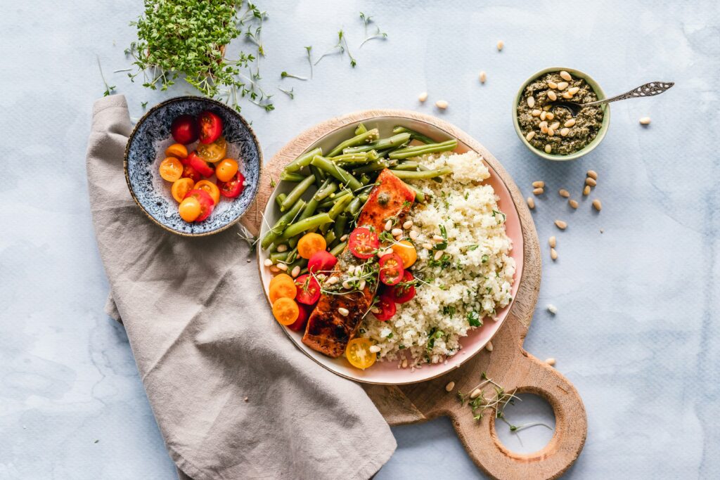 Mediterranean-style foods displayed on wooden board.